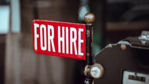 Red sign that says "for hire" in white text.