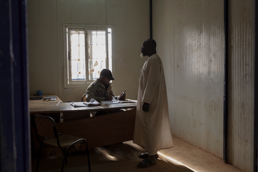 A border police officer sits at the desk of one of the control posts for those crossing the border, inside the border post of Makalondi, at the Niger-Burkina Faso border.