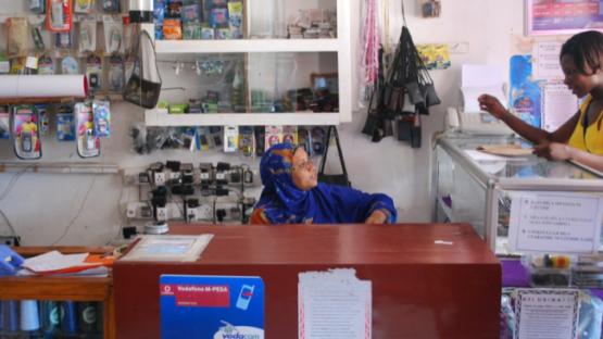 Two women at a mobile phone kiosk