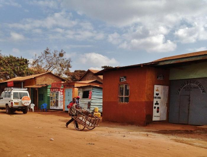 A boy with a barrow in a town in Tanzania