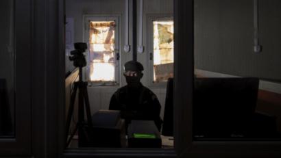 Man in the dark looking at laptop 