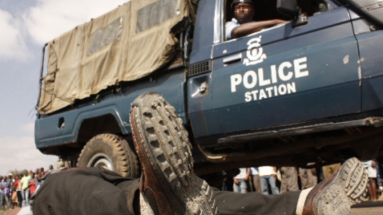 kenyan police car next to a corps