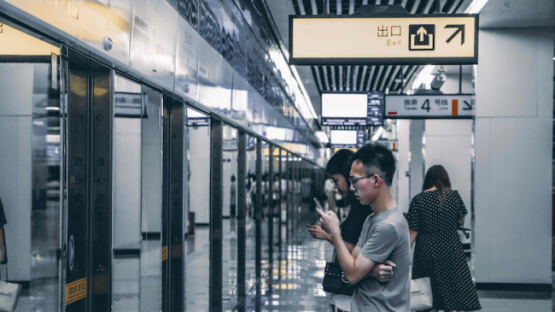 man standing under brown and black signage