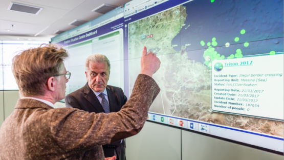 Dirk Vande Ryse, Head of the Frontex Situation Centre (FSC), on the left, giving explanations to Dimitris Avramopoulos, next to the screen of the FSC