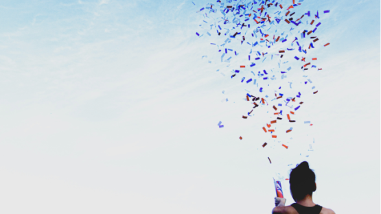 Person setting off confetti in celebration