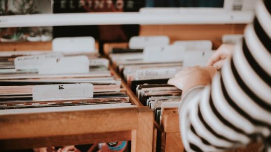 Hand going through a collection of vinyl music records