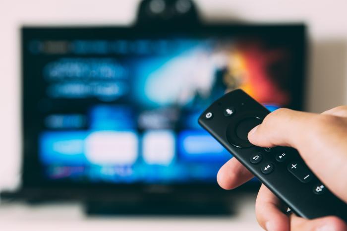 Someone using a TV remote