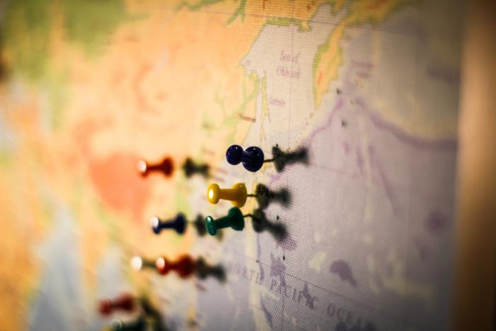 Map with pins on a board