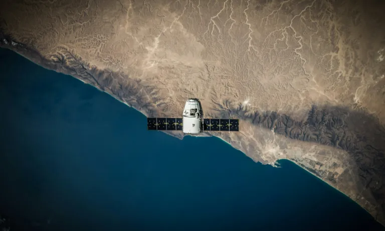 A satellite hovering above the coastline. 