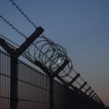 Photo of a border fence at night time