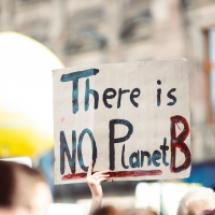 A protester holding a placard "There is no planet B"