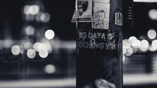 Image of signpost with poster 'big data is watching you'