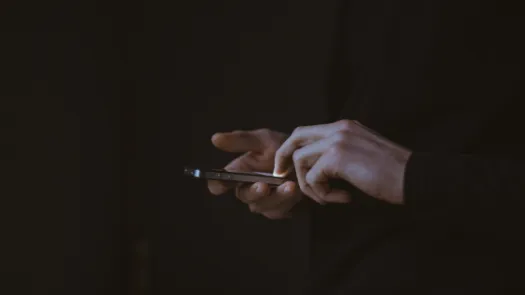 A person scrolling on a smart phone.