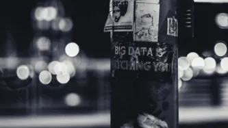 Image of signpost with poster 'big data is watching you'