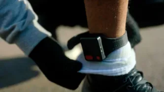 Photo of a GPS ankle tag on someone's leg